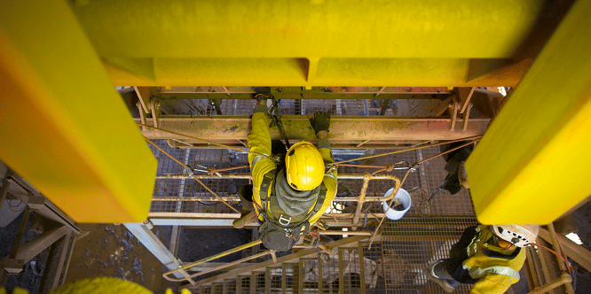 Rope access miner working at height wearing fall safety helmet